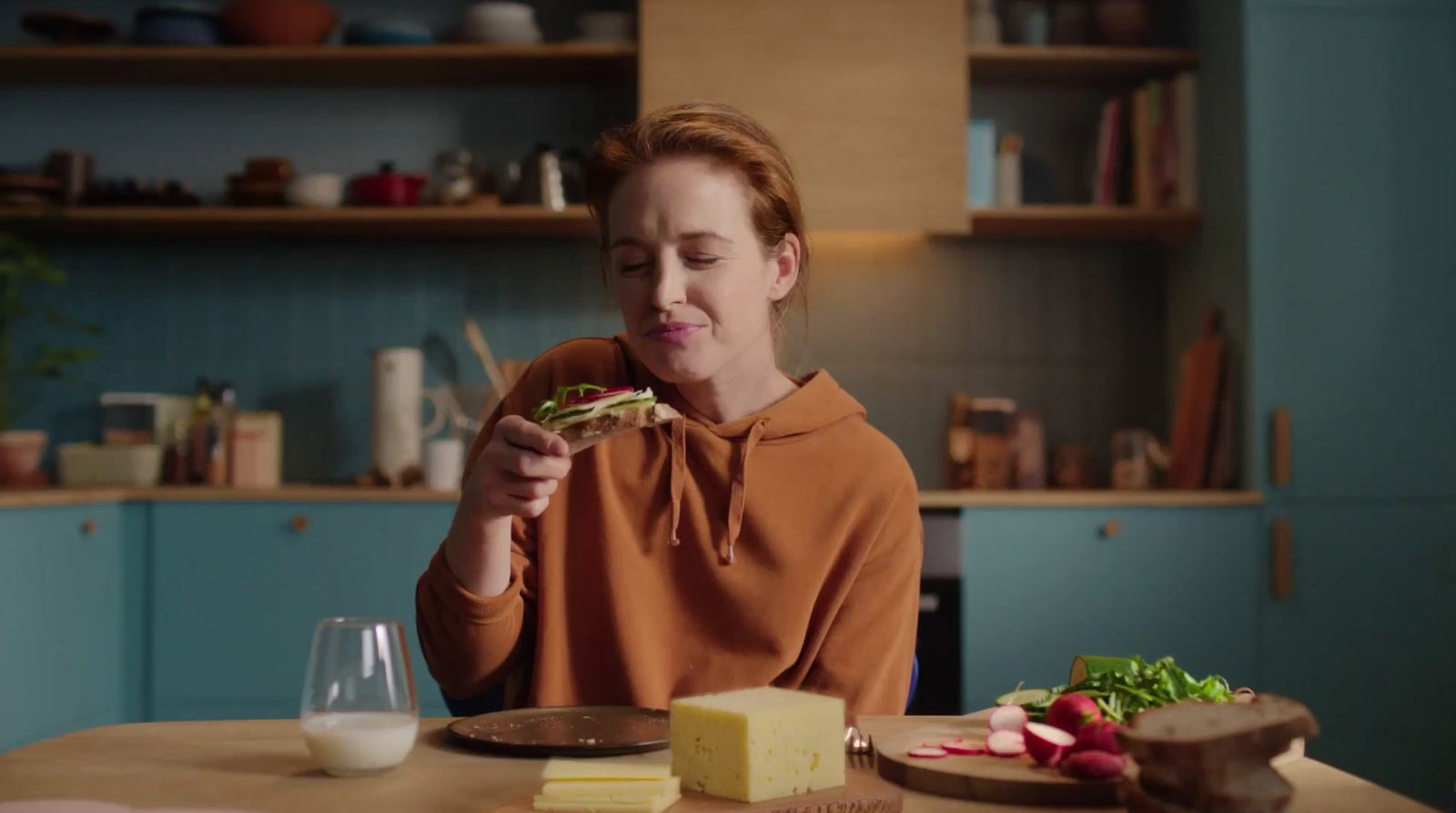 a woman sitting at a table eating food