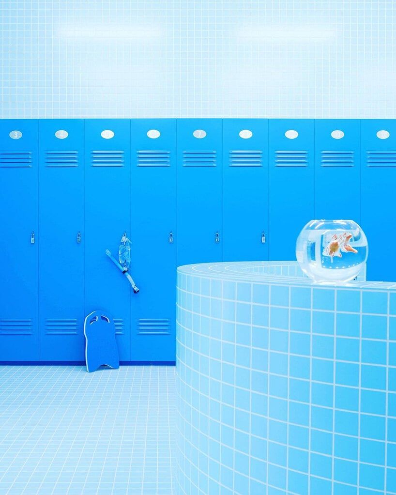 a bathroom with a blue wall and a fish bowl