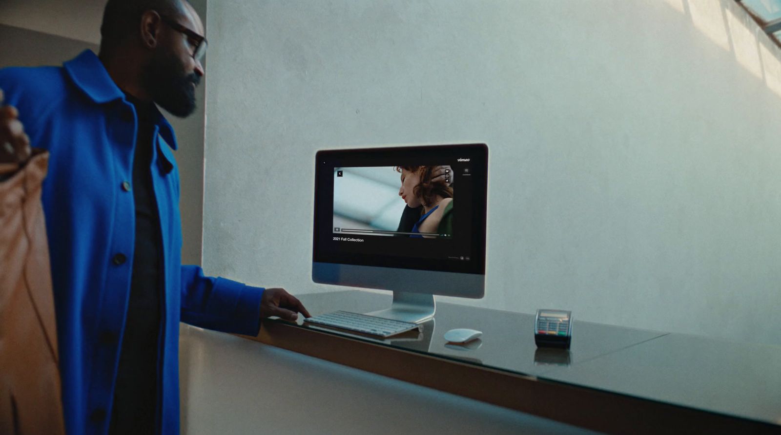 a man standing in front of a computer screen