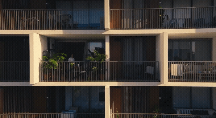 an apartment building with balconies and plants on the balconies