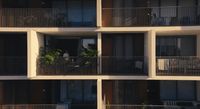 an apartment building with balconies and plants on the balconies