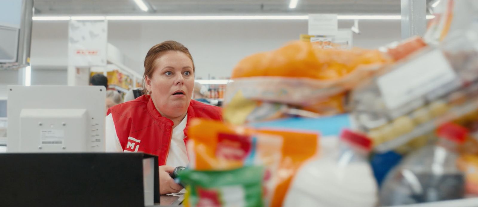 a woman in a store looking at a computer screen