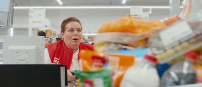 a woman in a store looking at a computer screen