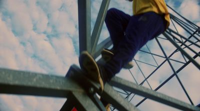 a man standing on top of a metal structure