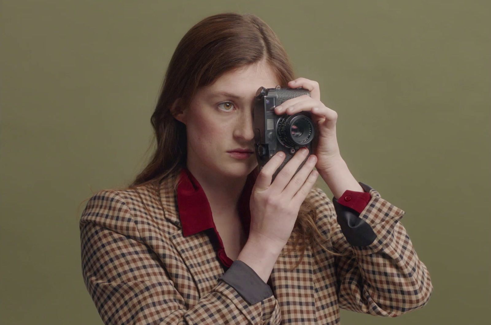 a woman taking a picture of herself with a camera