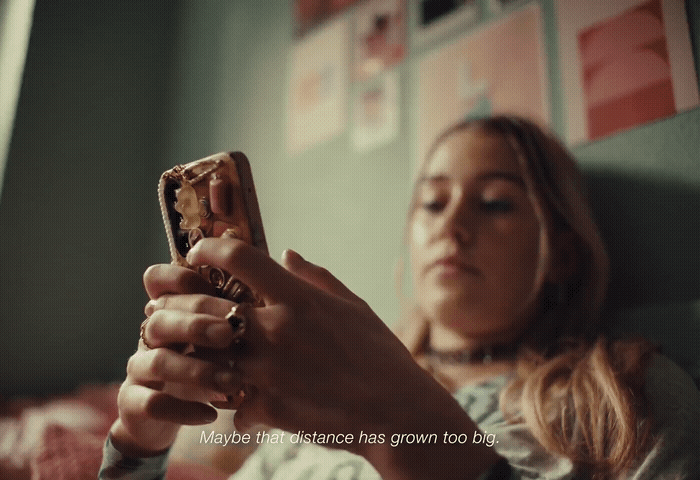 a woman holding a cell phone in her hand