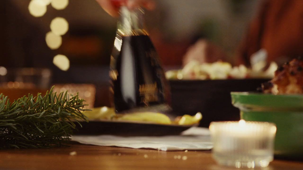 a table topped with plates of food and a bottle of wine