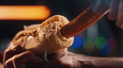 a close up of a person holding a doughnut