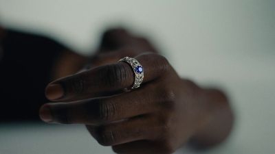 a close up of a person holding a ring