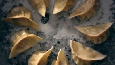 a group of dumplings sitting on top of a pan