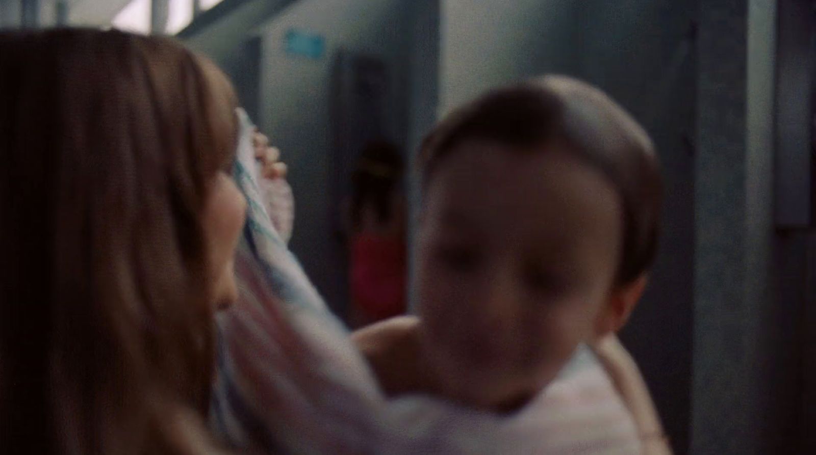 a woman holding a baby in her arms