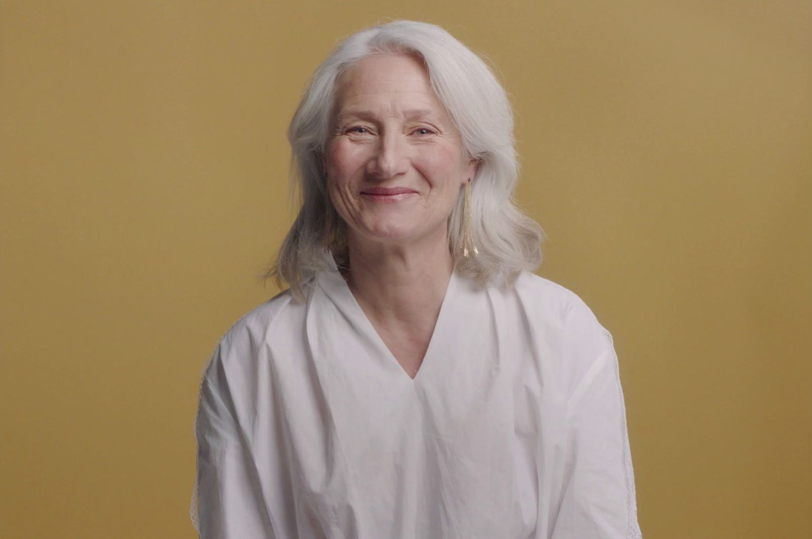 a woman with white hair and a white shirt