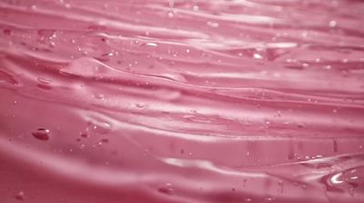 a close up of a pink liquid filled with water