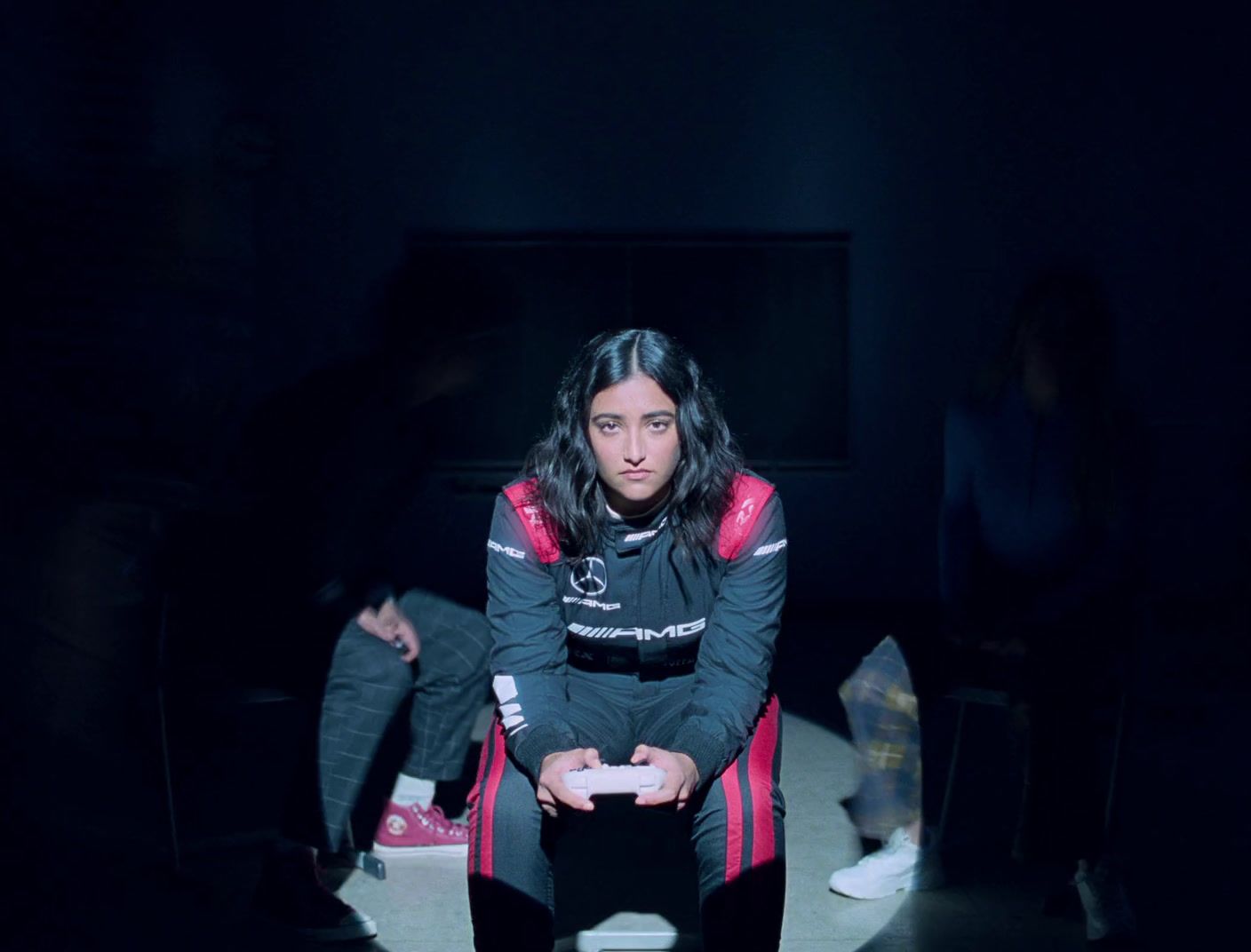 a woman sitting in a chair in a dark room