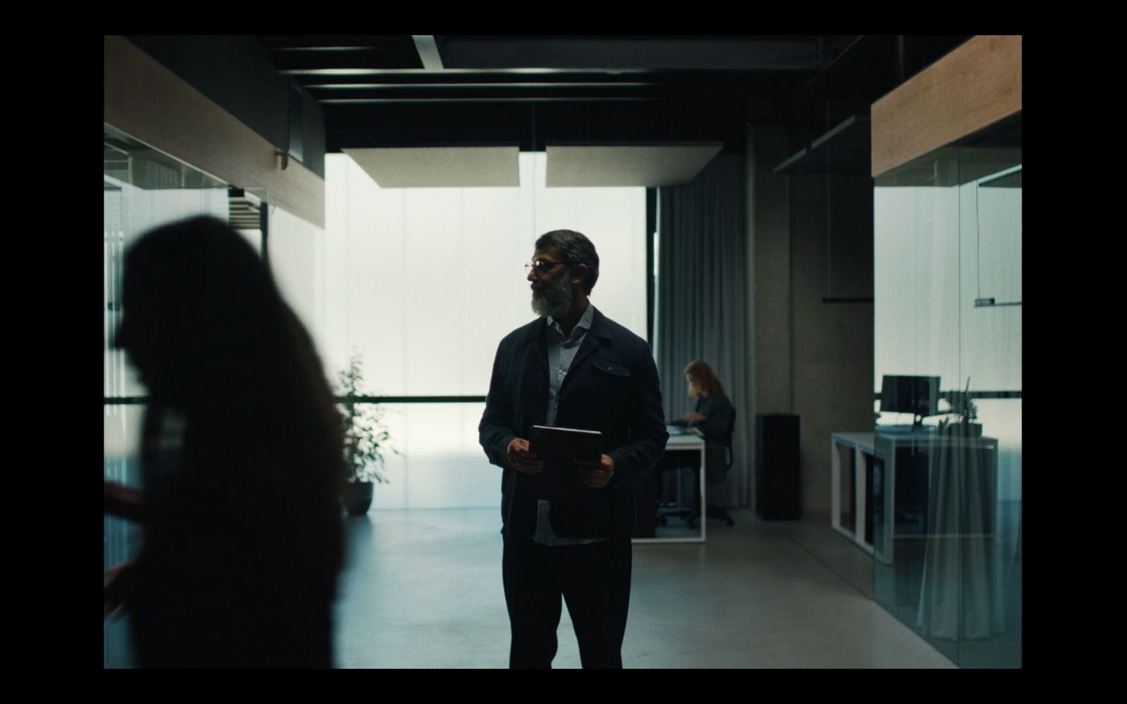 a man in a suit standing in a room