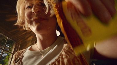 a close up of a person holding a banana