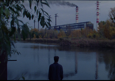 a man standing in front of a body of water