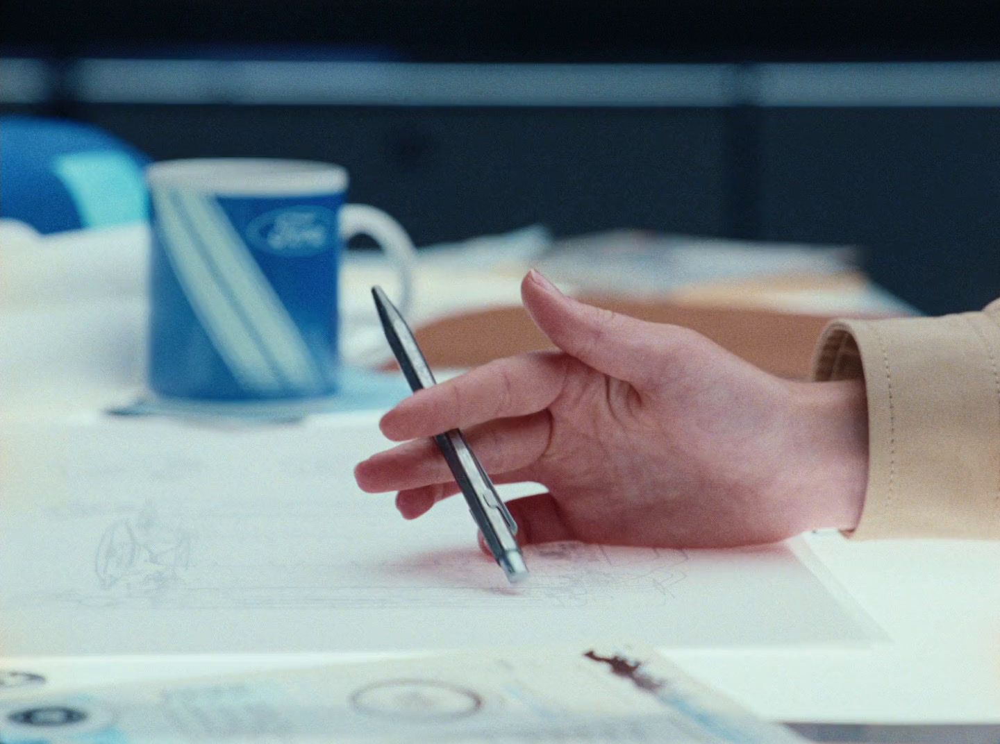 a person writing on a piece of paper with a pen