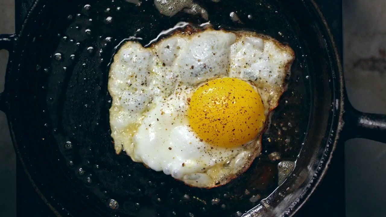 a fried egg in a frying pan on a stove