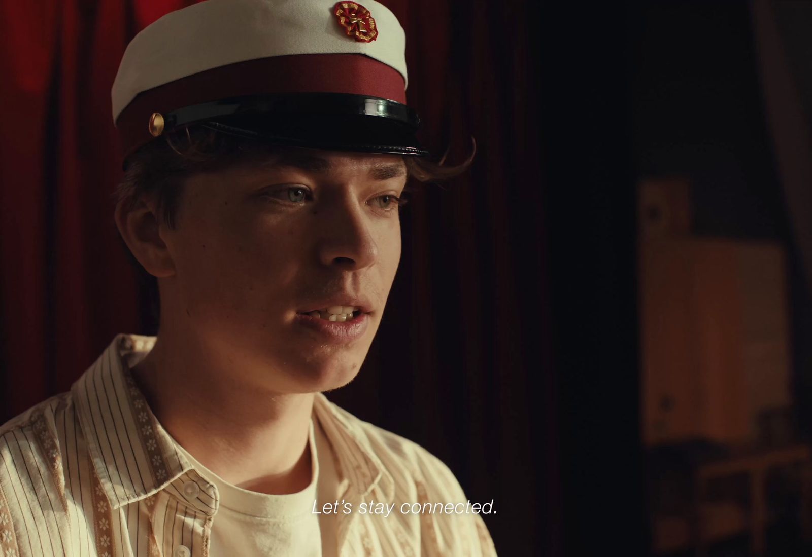 a young man wearing a red and white hat