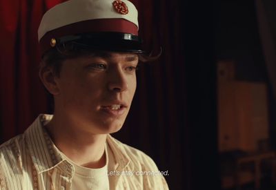 a young man wearing a red and white hat