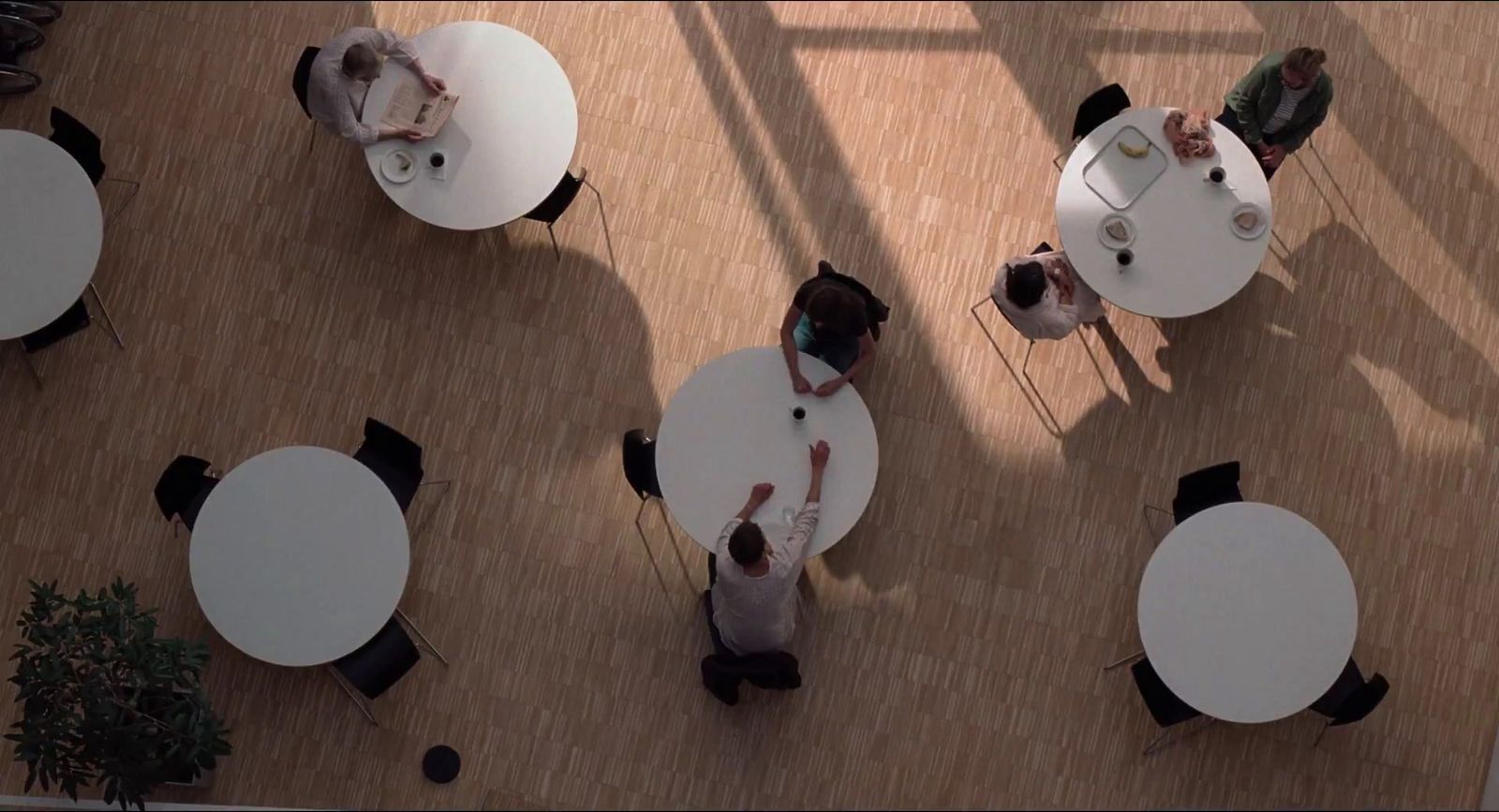 a group of people sitting at tables in a room