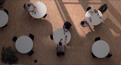 a group of people sitting at tables in a room