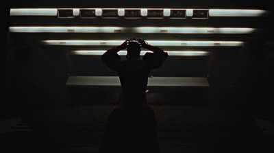 a person standing in a dark room holding a camera