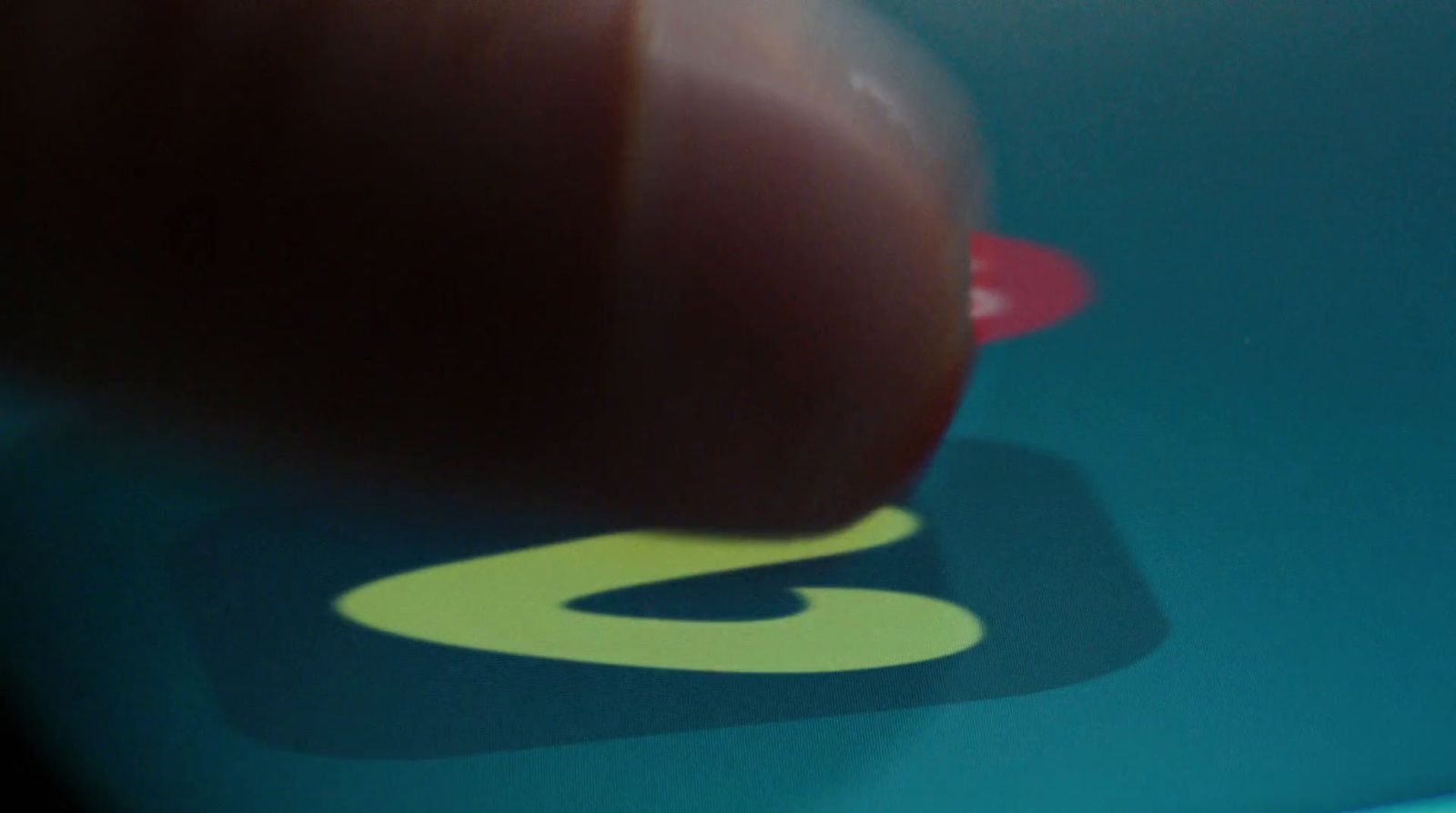 a close up of a hand pressing a button on a tablet