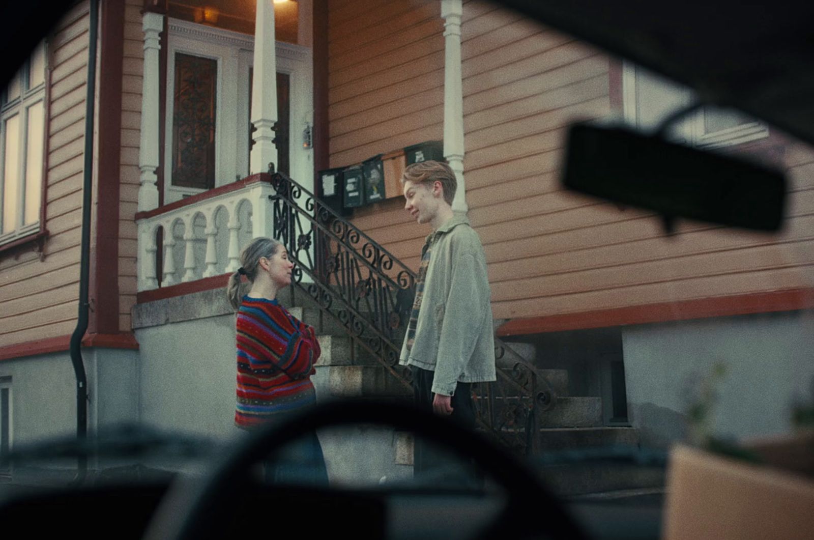 a couple of people that are standing in front of a house