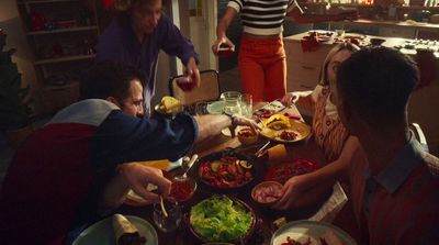 a group of people sitting around a table eating food