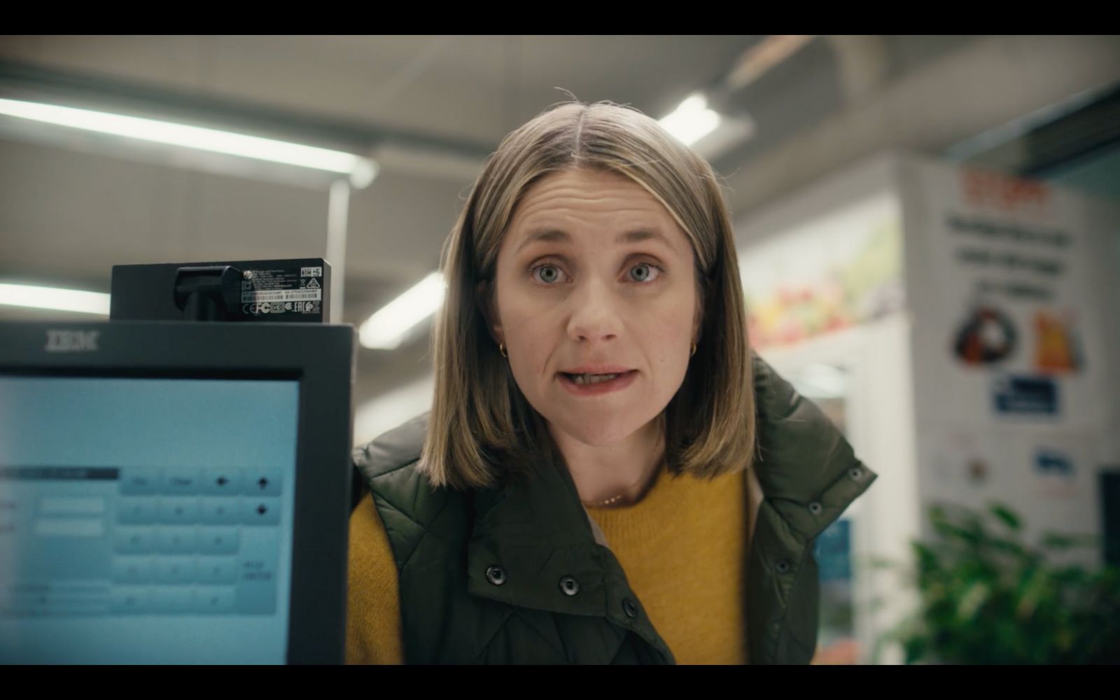 a woman looking at a computer screen with a surprised look on her face