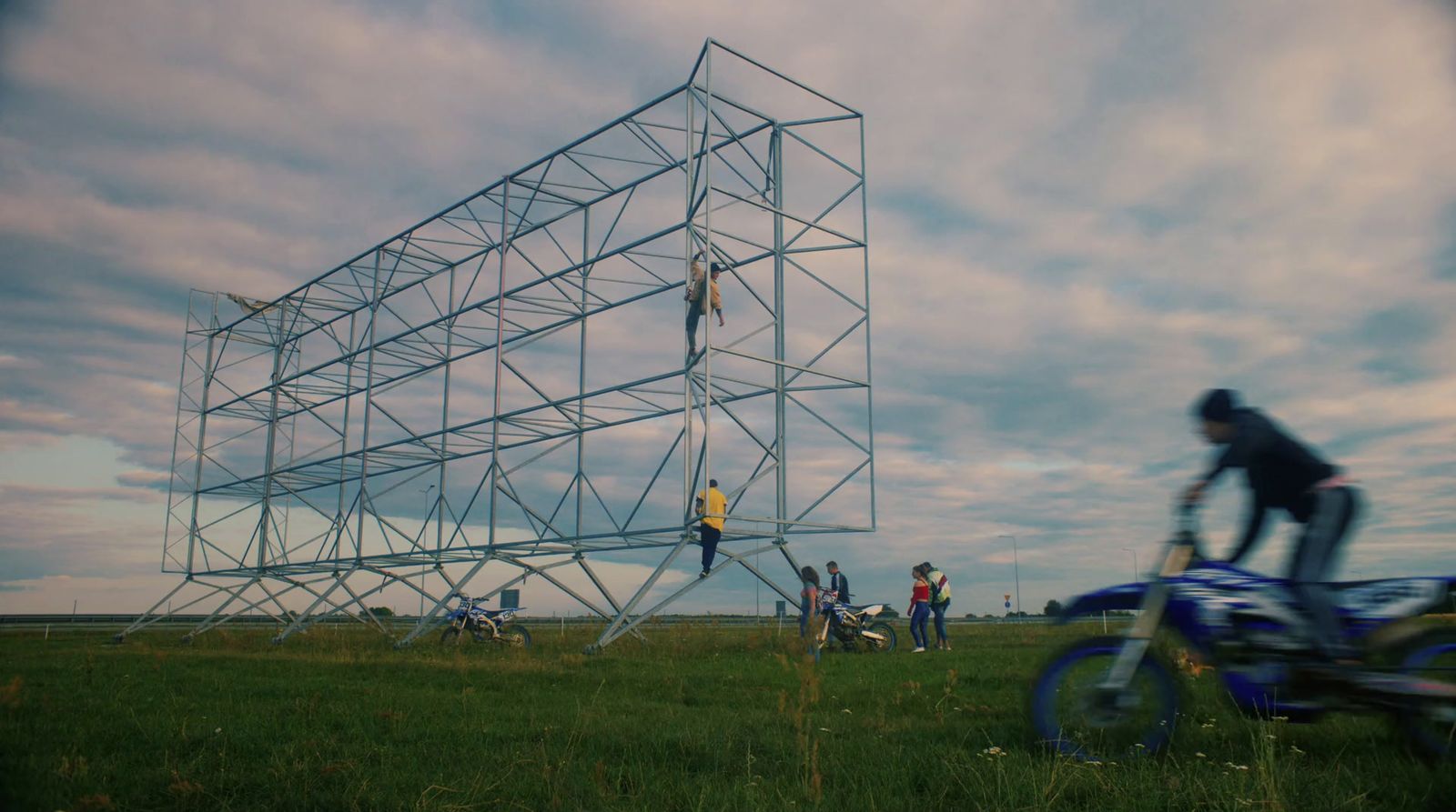 a man riding a bike next to a tall structure