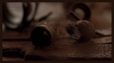 a close up of a chocolate doughnut on a table