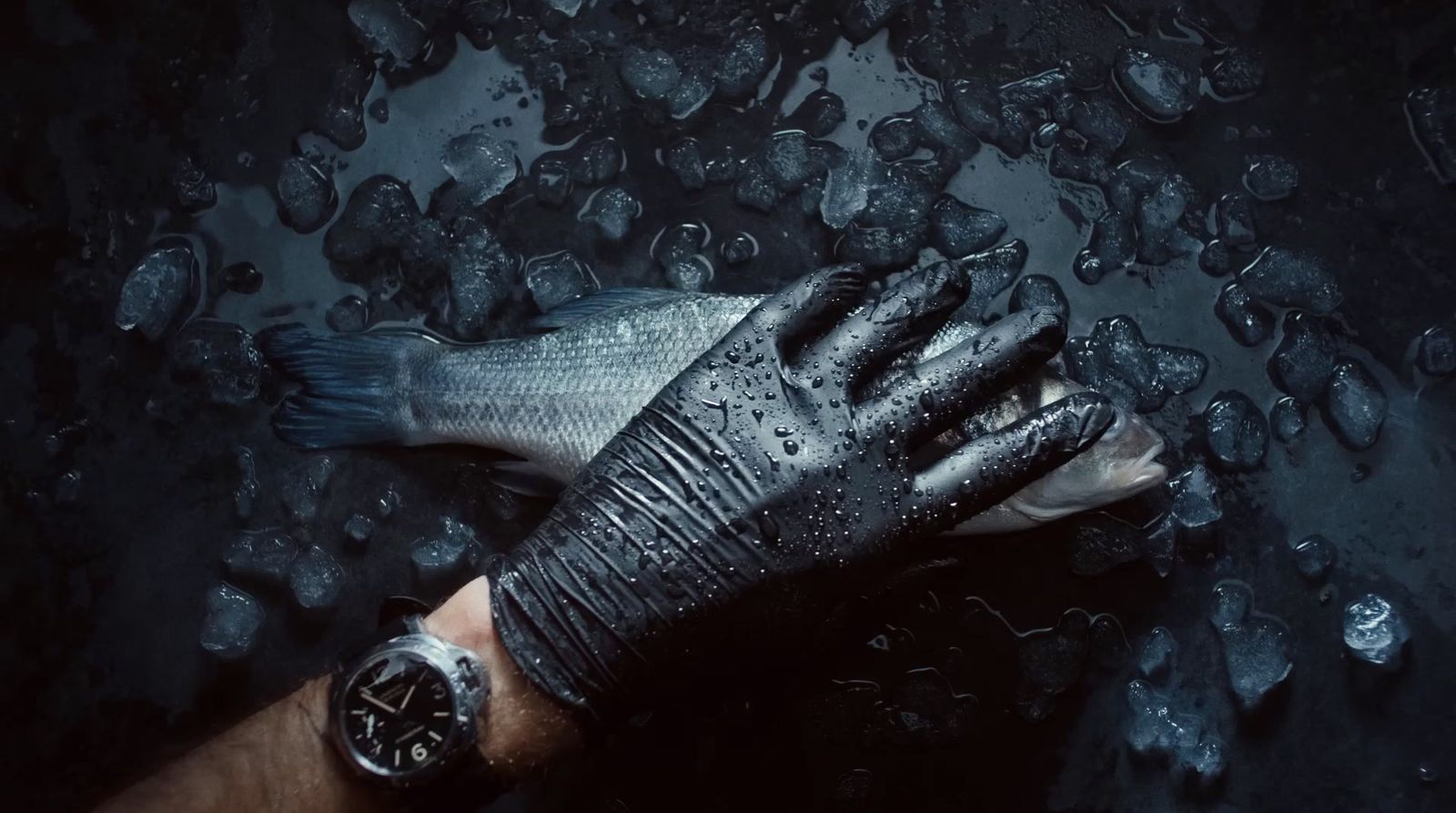 a person's hand with a wet glove on it