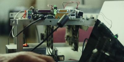 a person working on a computer with a lot of wires