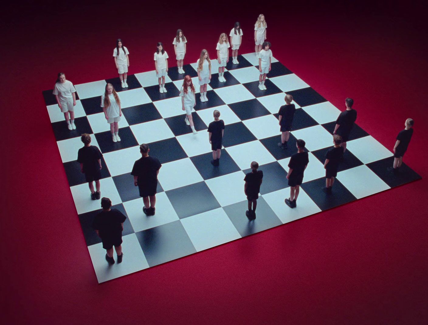 a group of people standing on top of a chess board