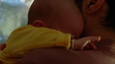 a close up of a person holding a baby