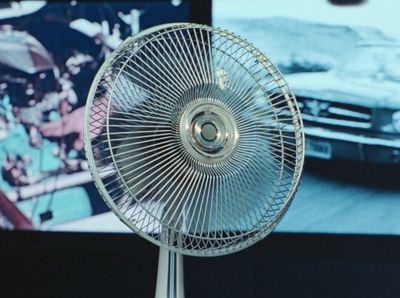 a silver fan sitting on top of a table