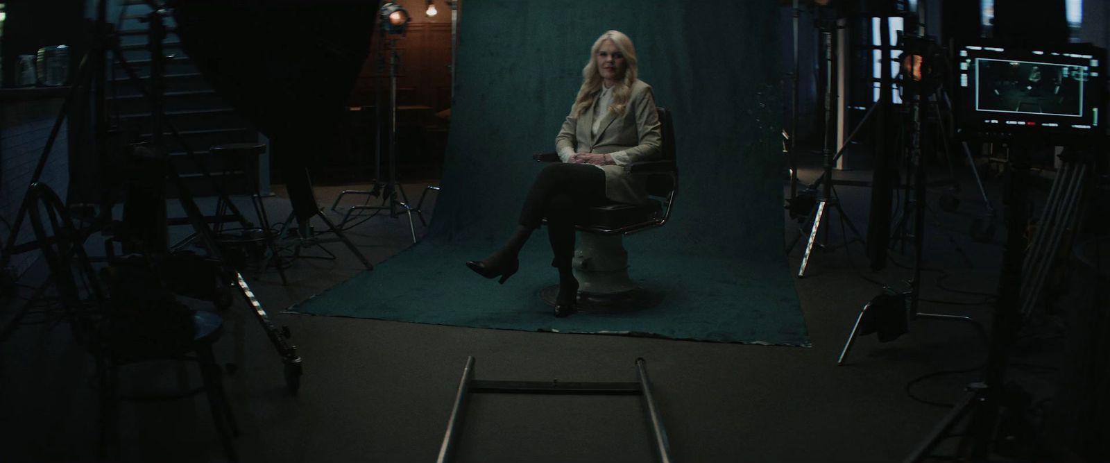 a woman sitting in a chair in a dark room