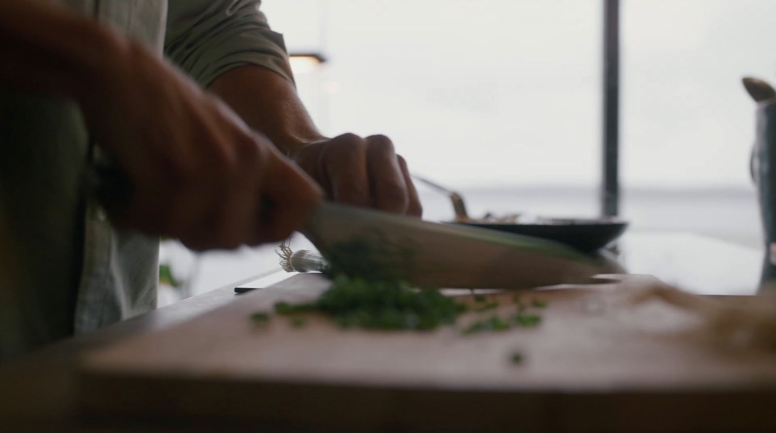 a person chopping vegetables on a cutting board