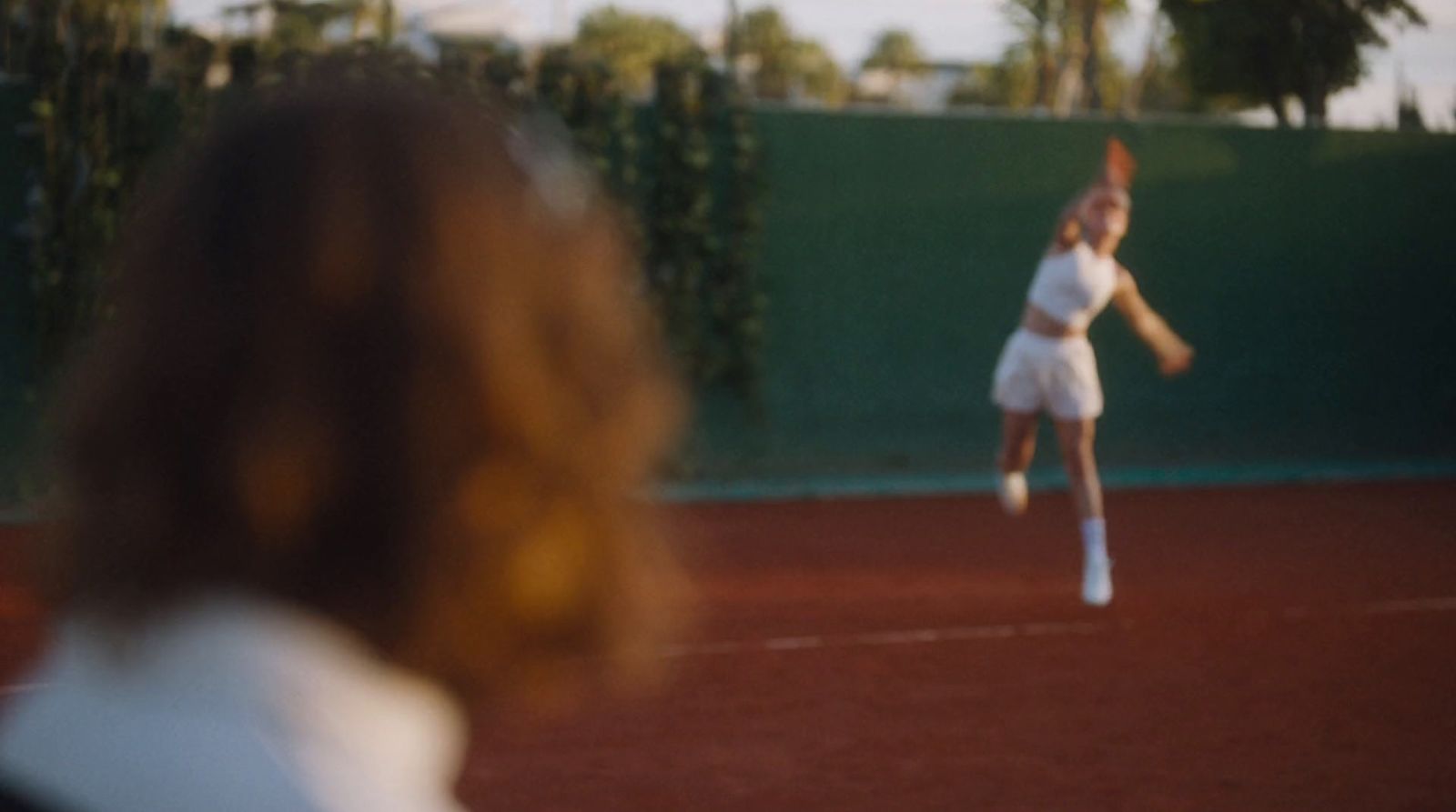 a woman on a court with a tennis racket