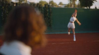 a woman on a court with a tennis racket