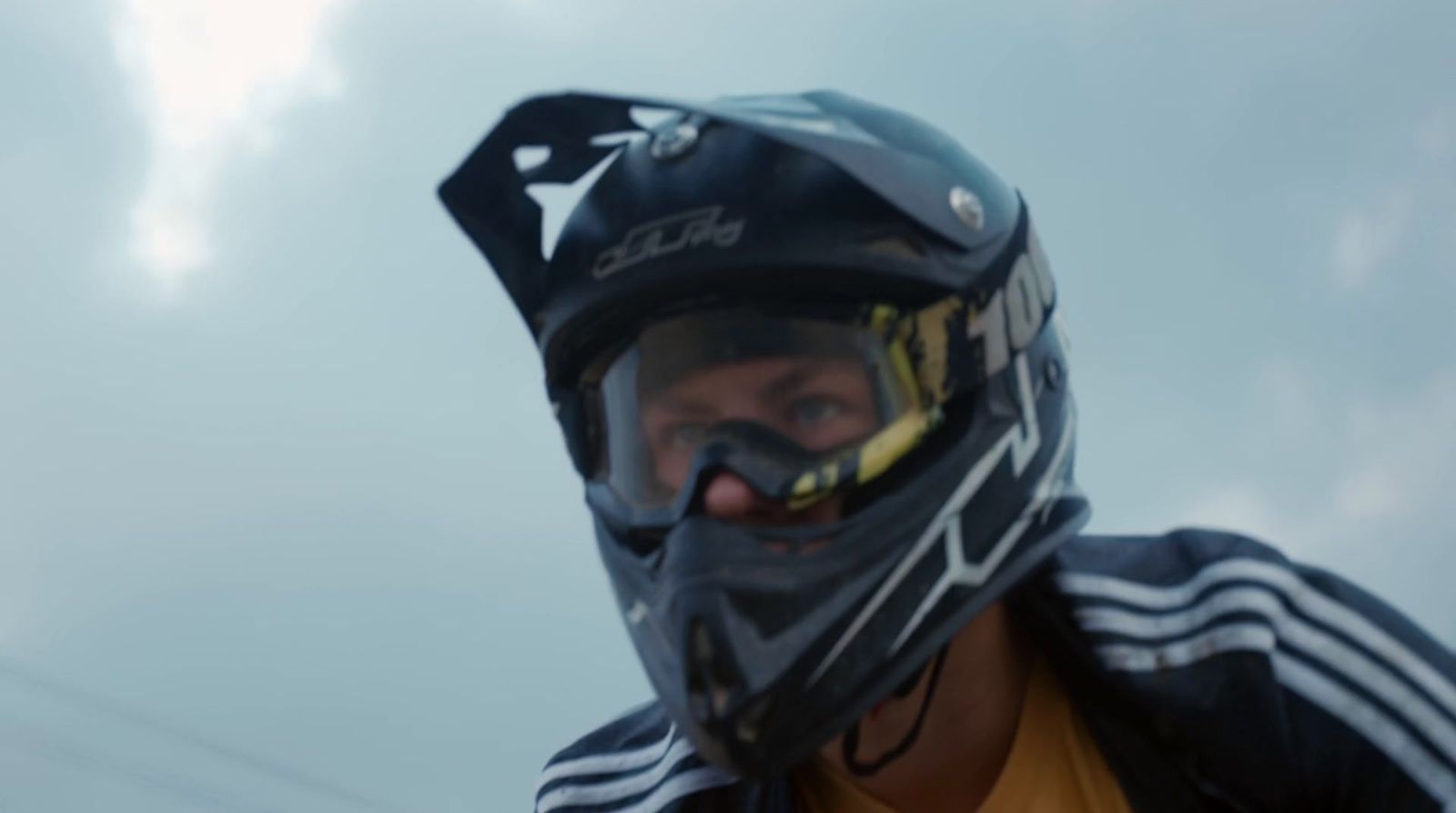 a man wearing a black helmet and a yellow shirt