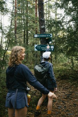 a couple of people that are standing in the woods