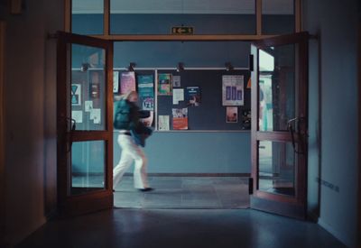 a woman is walking out of a building