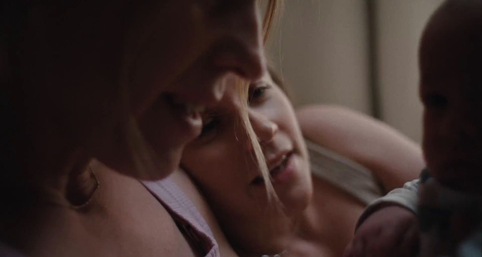 a woman holding a baby in her arms