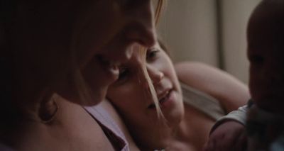a woman holding a baby in her arms