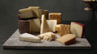 a bunch of different types of cheese on a table