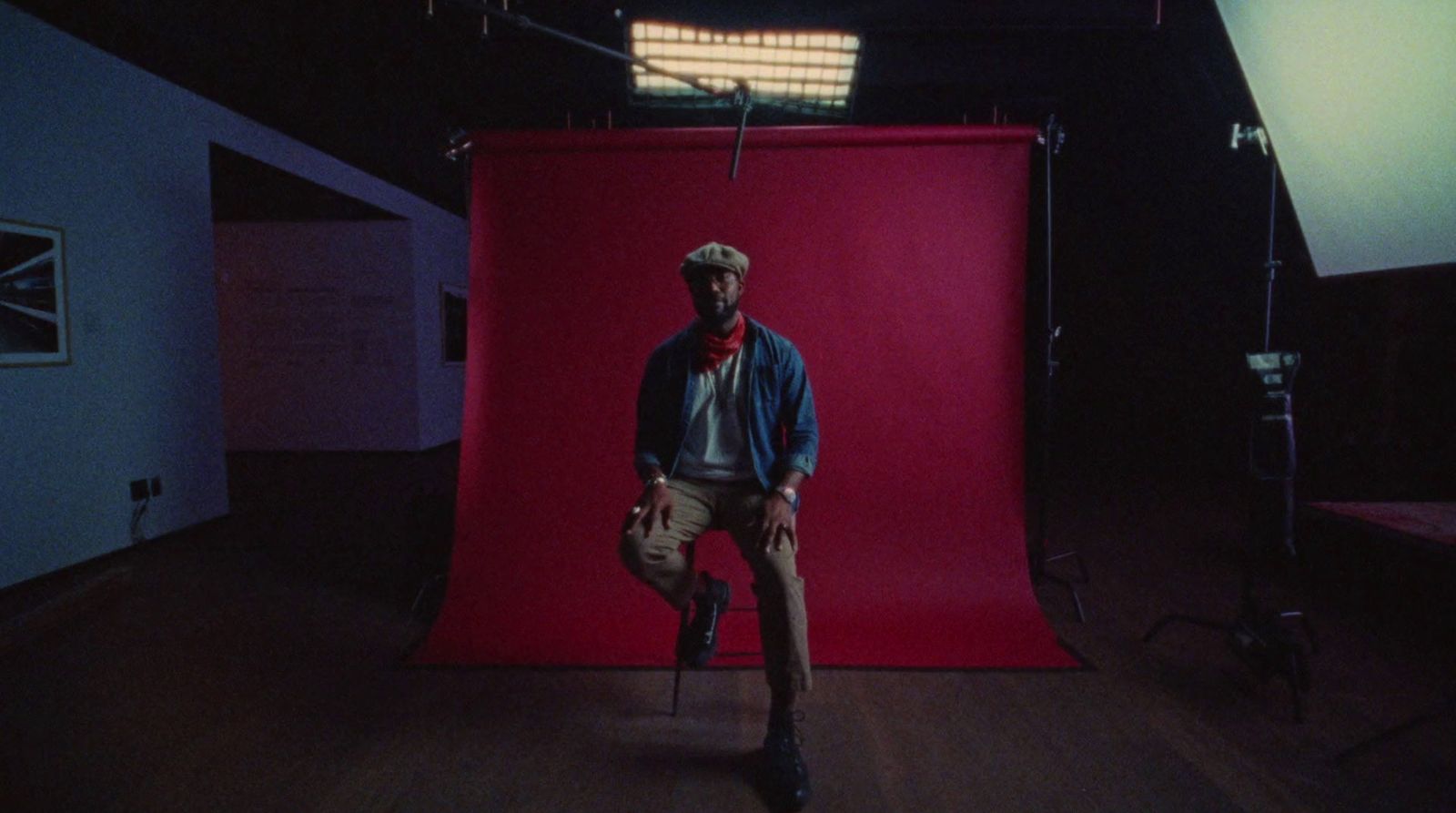 a man standing in front of a red backdrop